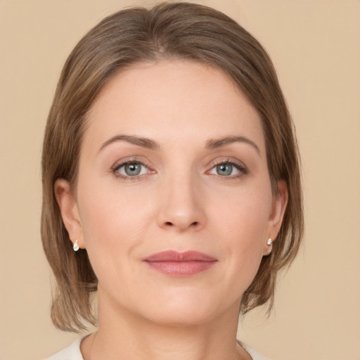 Joyful white young-adult female with medium  brown hair and green eyes