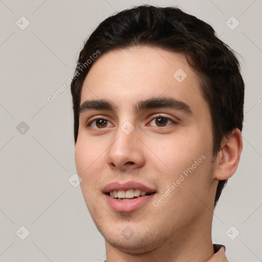 Joyful white young-adult male with short  black hair and brown eyes