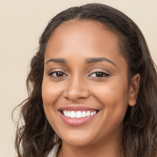 Joyful latino young-adult female with long  brown hair and brown eyes