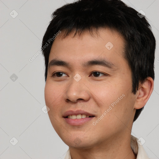 Joyful asian young-adult male with short  black hair and brown eyes