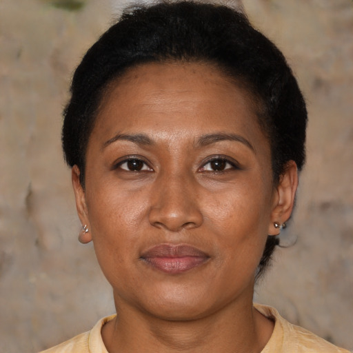 Joyful latino adult female with short  brown hair and brown eyes