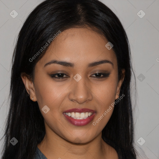 Joyful latino young-adult female with long  black hair and brown eyes