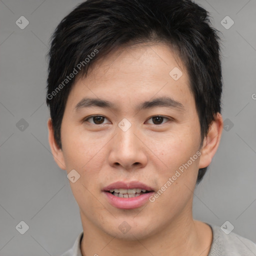 Joyful asian young-adult male with short  brown hair and brown eyes