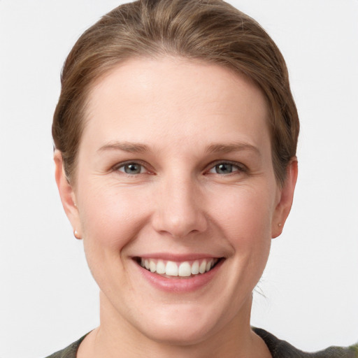 Joyful white young-adult female with short  brown hair and grey eyes