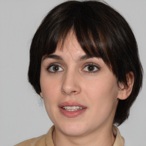 Joyful white young-adult female with medium  brown hair and green eyes