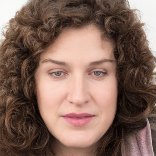 Joyful white young-adult female with long  brown hair and green eyes