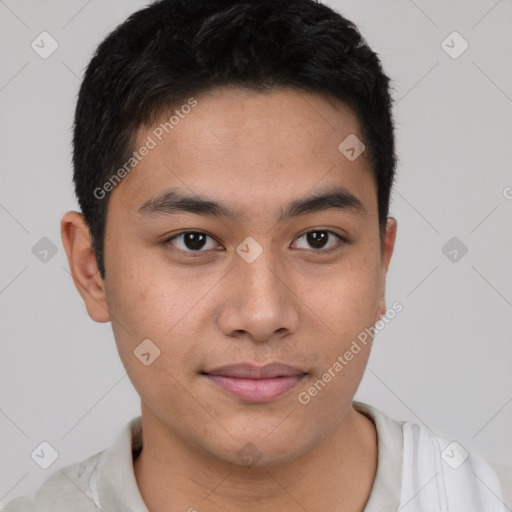 Joyful latino young-adult male with short  brown hair and brown eyes