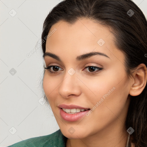 Joyful latino young-adult female with long  brown hair and brown eyes