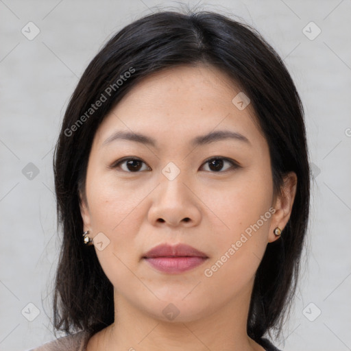 Joyful asian young-adult female with medium  brown hair and brown eyes