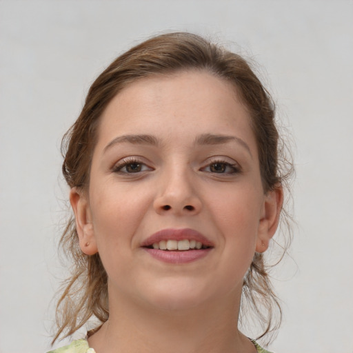 Joyful white young-adult female with medium  brown hair and grey eyes