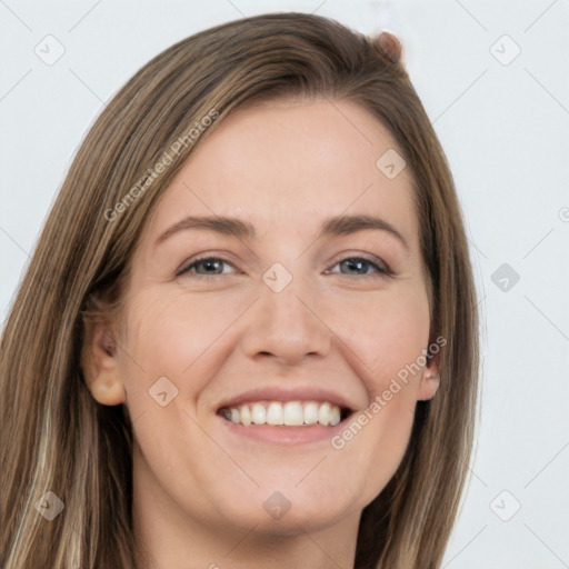 Joyful white young-adult female with long  brown hair and grey eyes