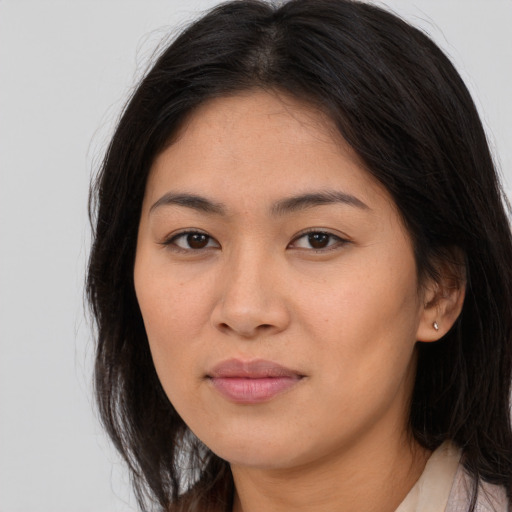 Joyful asian young-adult female with long  brown hair and brown eyes