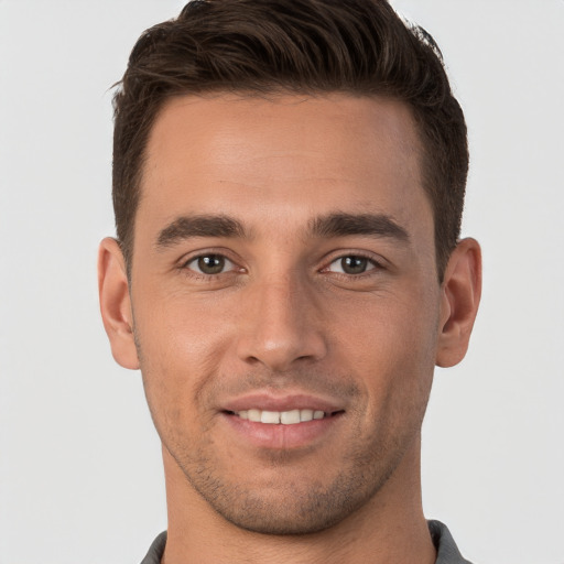 Joyful white young-adult male with short  brown hair and brown eyes