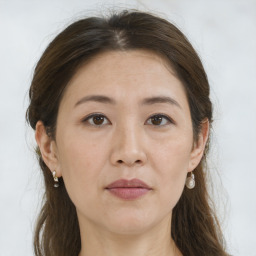 Joyful white adult female with long  brown hair and brown eyes