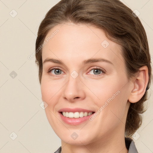 Joyful white young-adult female with medium  brown hair and green eyes