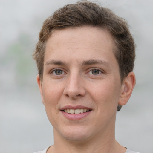 Joyful white young-adult female with short  brown hair and grey eyes