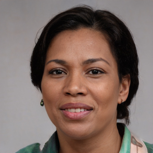Joyful asian adult female with medium  brown hair and brown eyes