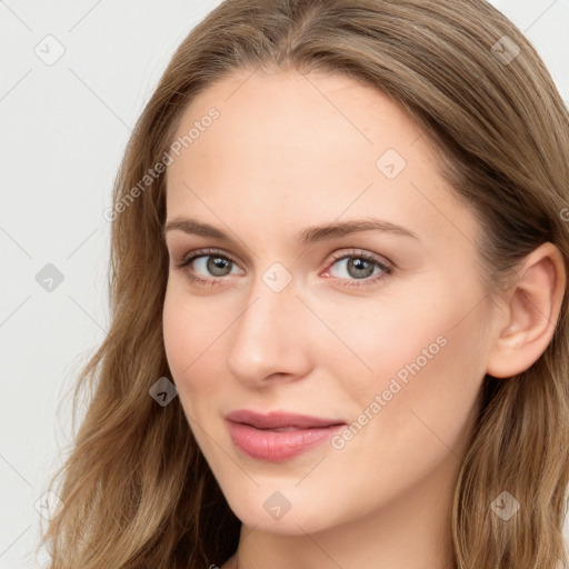 Joyful white young-adult female with long  brown hair and blue eyes