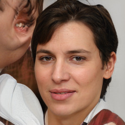 Joyful white adult female with medium  brown hair and brown eyes