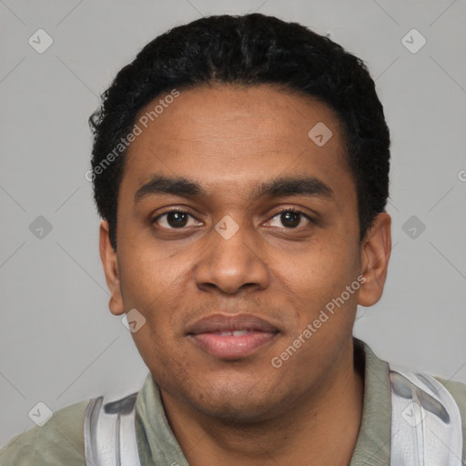 Joyful black young-adult male with short  black hair and brown eyes