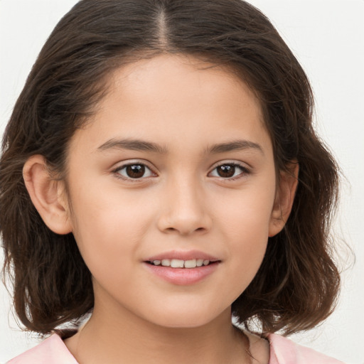 Joyful white child female with medium  brown hair and brown eyes