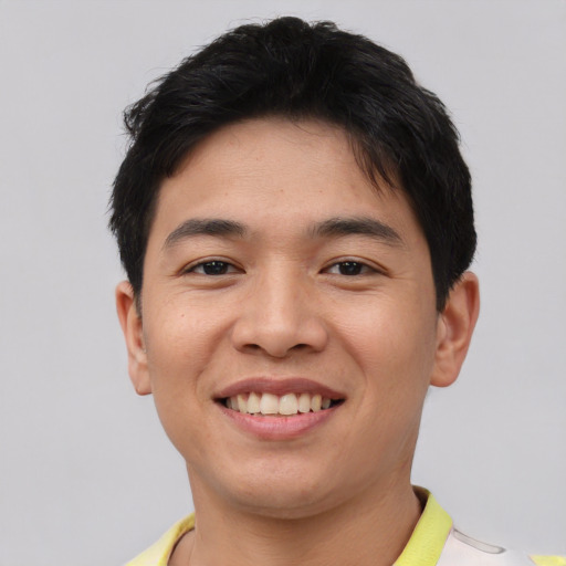 Joyful asian young-adult male with short  black hair and brown eyes