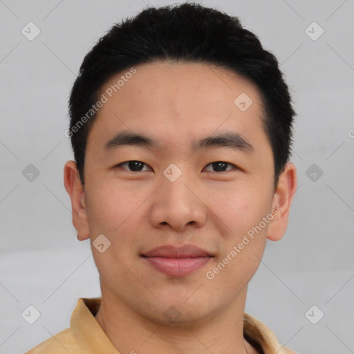 Joyful asian young-adult male with short  black hair and brown eyes