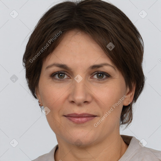 Joyful white adult female with medium  brown hair and grey eyes