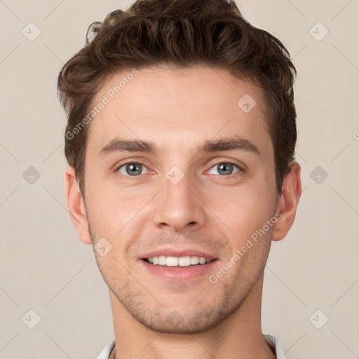 Joyful white young-adult male with short  brown hair and grey eyes