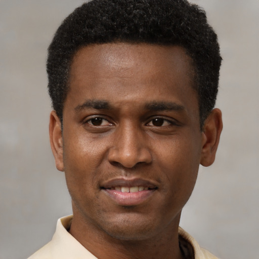 Joyful black young-adult male with short  black hair and brown eyes