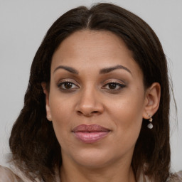 Joyful white young-adult female with long  brown hair and brown eyes