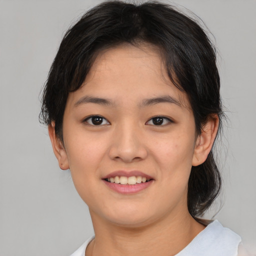Joyful asian young-adult female with medium  brown hair and brown eyes