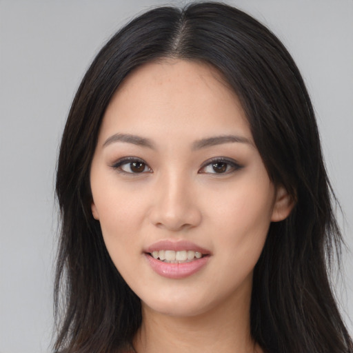 Joyful asian young-adult female with long  black hair and brown eyes