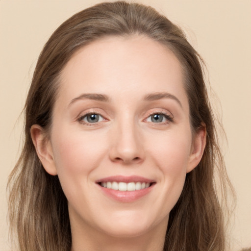 Joyful white young-adult female with long  brown hair and grey eyes