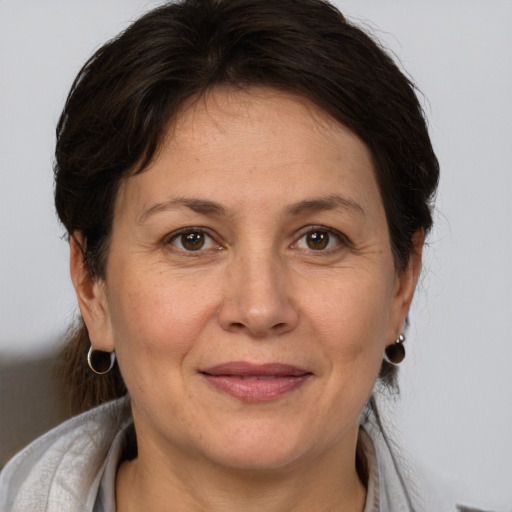 Joyful white adult female with medium  brown hair and brown eyes