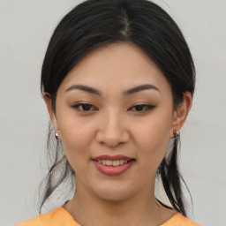 Joyful asian young-adult female with medium  brown hair and brown eyes