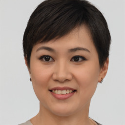 Joyful asian young-adult female with short  brown hair and brown eyes