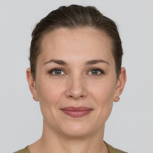 Joyful white young-adult female with short  brown hair and grey eyes