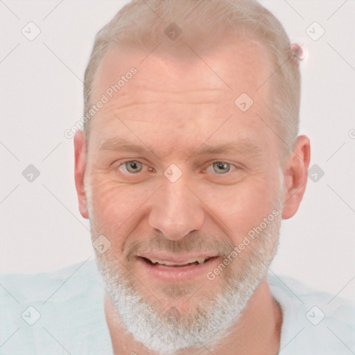 Joyful white adult male with short  brown hair and blue eyes