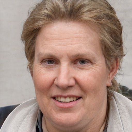 Joyful white middle-aged female with medium  brown hair and brown eyes