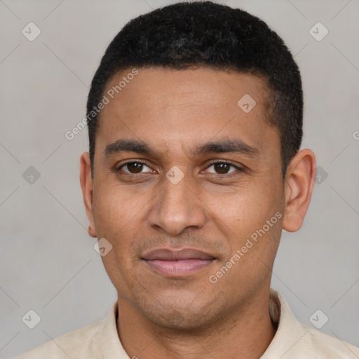 Joyful latino young-adult male with short  black hair and brown eyes