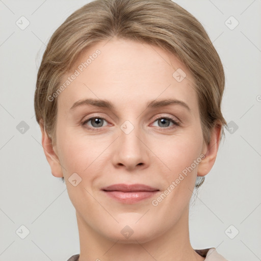 Joyful white young-adult female with short  brown hair and grey eyes