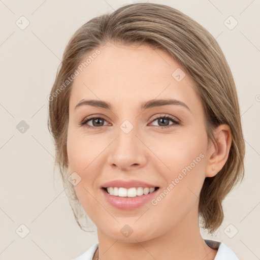 Joyful white young-adult female with medium  brown hair and green eyes