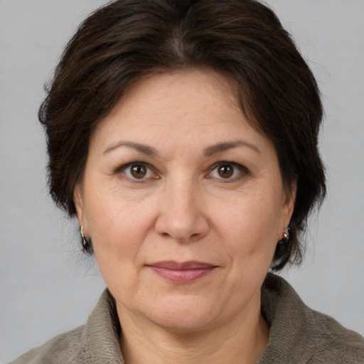 Joyful white adult female with medium  brown hair and brown eyes