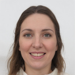 Joyful white young-adult female with medium  brown hair and green eyes