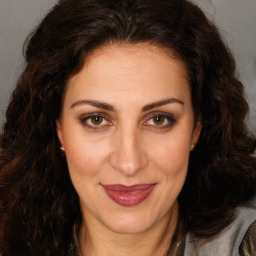 Joyful white adult female with long  brown hair and brown eyes