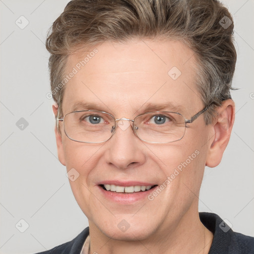 Joyful white adult male with short  brown hair and grey eyes