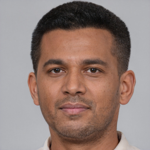 Neutral latino young-adult male with short  brown hair and brown eyes