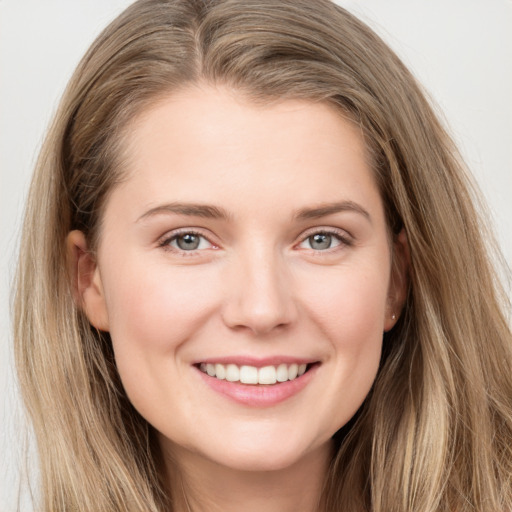 Joyful white young-adult female with long  brown hair and grey eyes