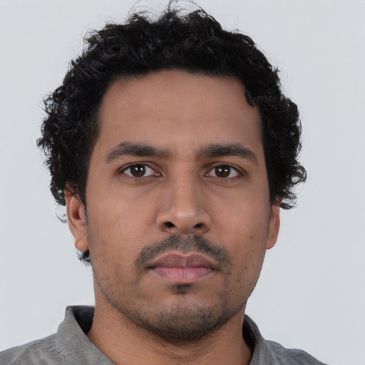 Neutral latino young-adult male with short  brown hair and brown eyes